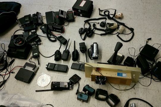 Part of the equipment haul police said they recovered from three men accused of robbing people by impersonating cops.